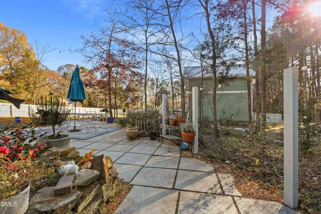 a living room with furniture a large window and a fireplace