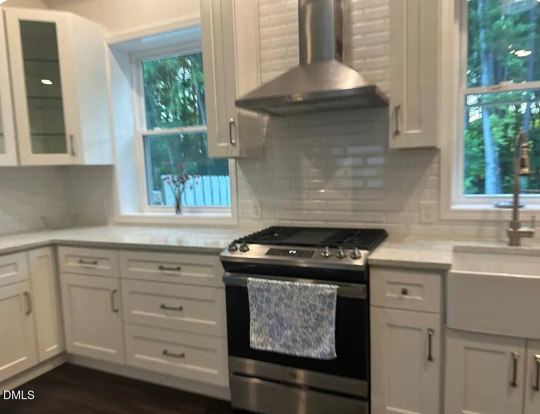 6202 Montgomery Ests Road Hillsborough, NC 27278 - Photo 63 of 91 a kitchen with a stove and white cabinets