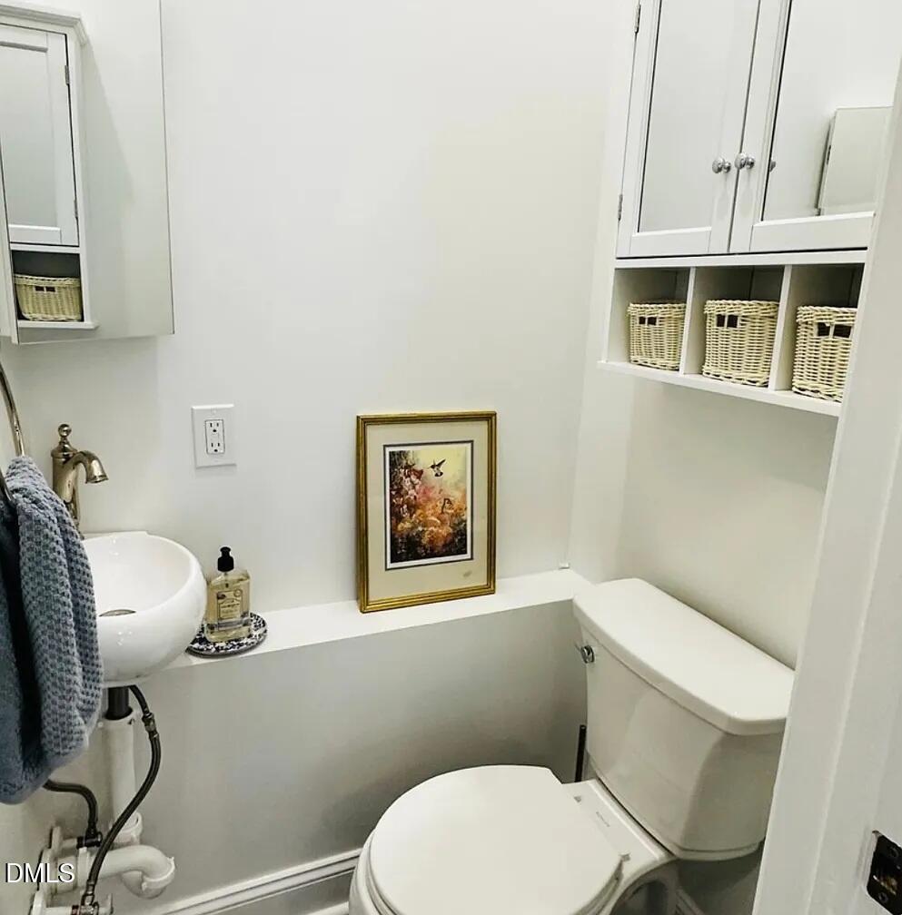 6202 Montgomery Ests Road Hillsborough, NC 27278 - Photo 64 of 91 a bathroom with a toilet a sink and mirror