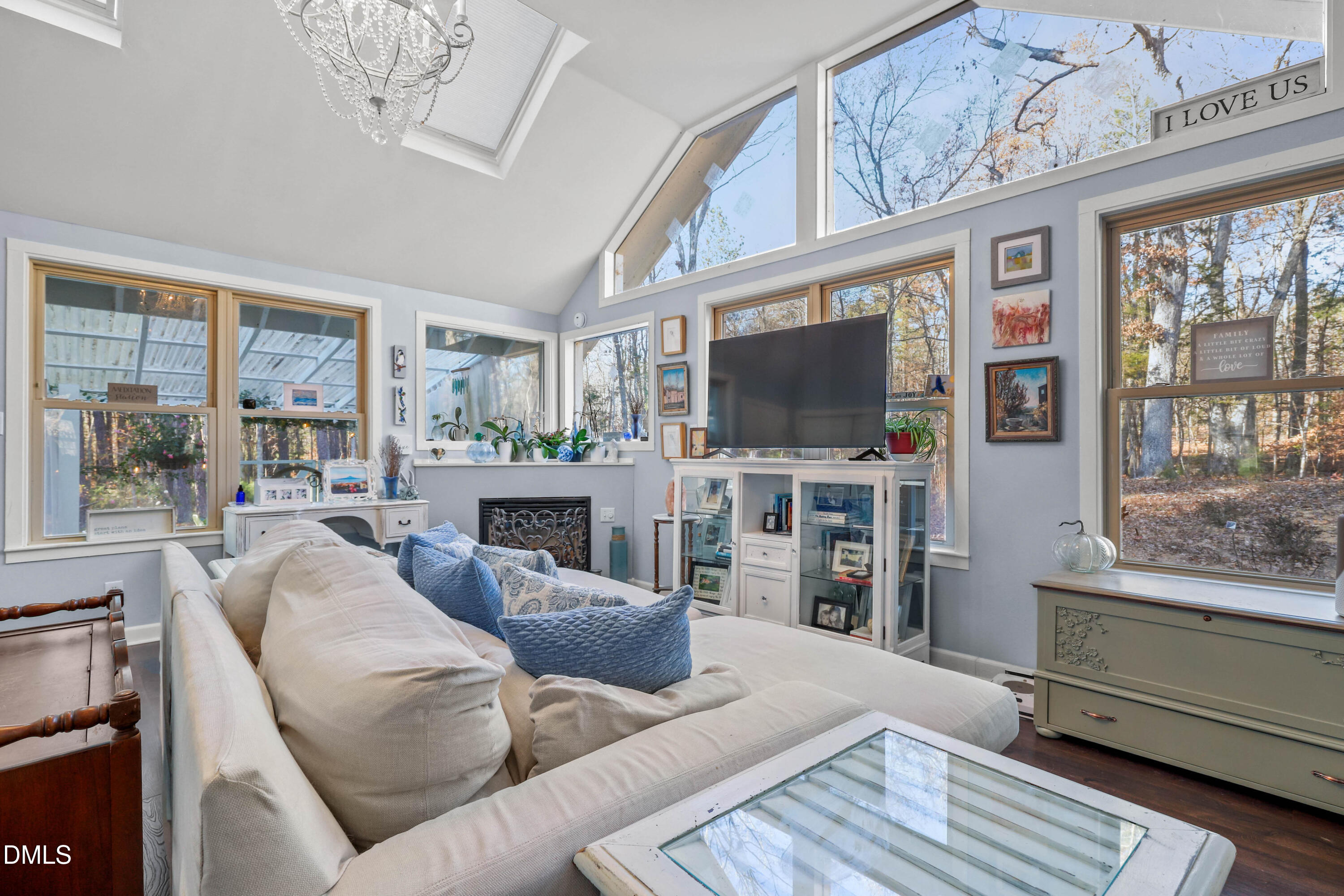 6202 Montgomery Ests Road Hillsborough, NC 27278 - Photo 10 of 91 a living room with furniture a flat screen tv and a floor to ceiling window