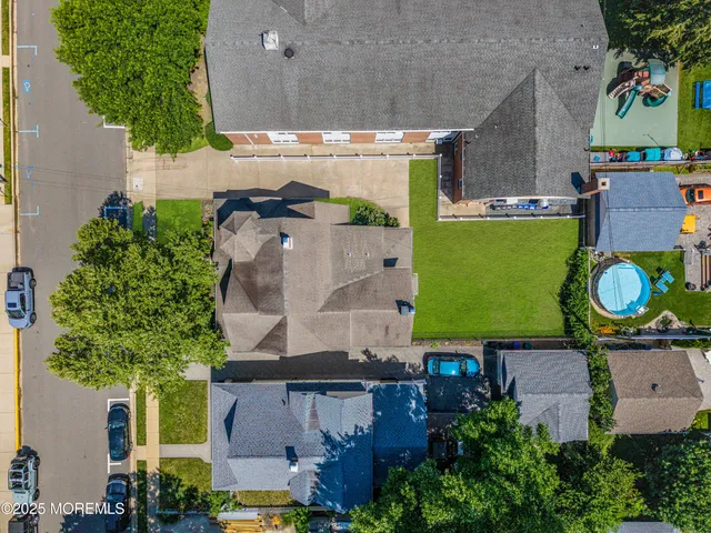 an aerial view of a house with a yard basket ball court and outdoor seating
