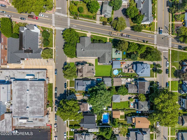 a front view of a house with a yard and trees