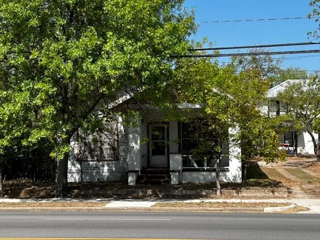 a view of street along with house and trees