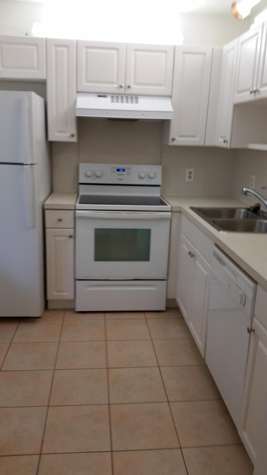 800 Northwest Fork Road, Unit 71 Stuart, FL 34994 - Photo 11 of 23 a kitchen with a stove sink and cabinets