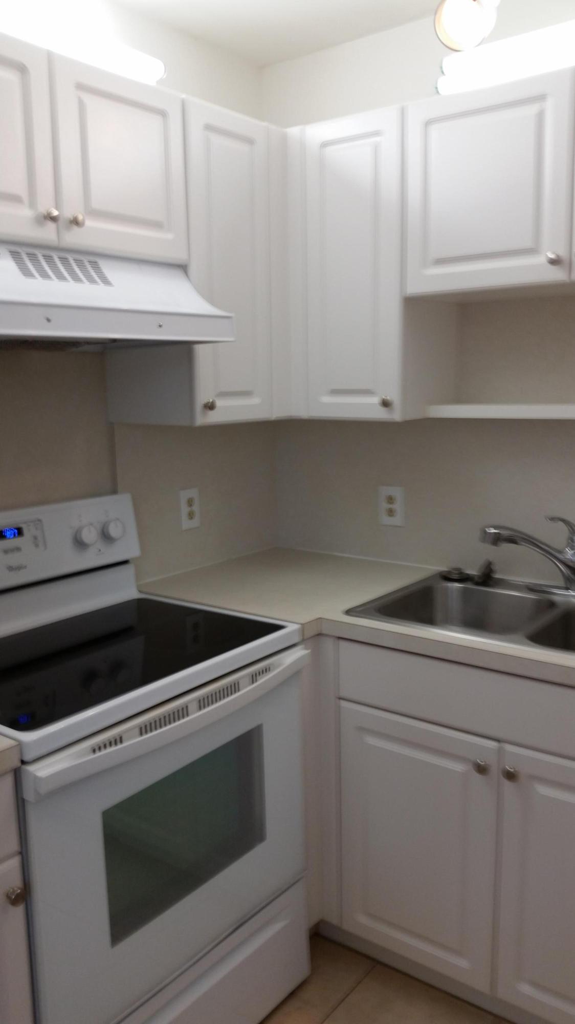 800 Northwest Fork Road, Unit 71 Stuart, FL 34994 - Photo 12 of 23 a stove top oven sitting inside of a kitchen