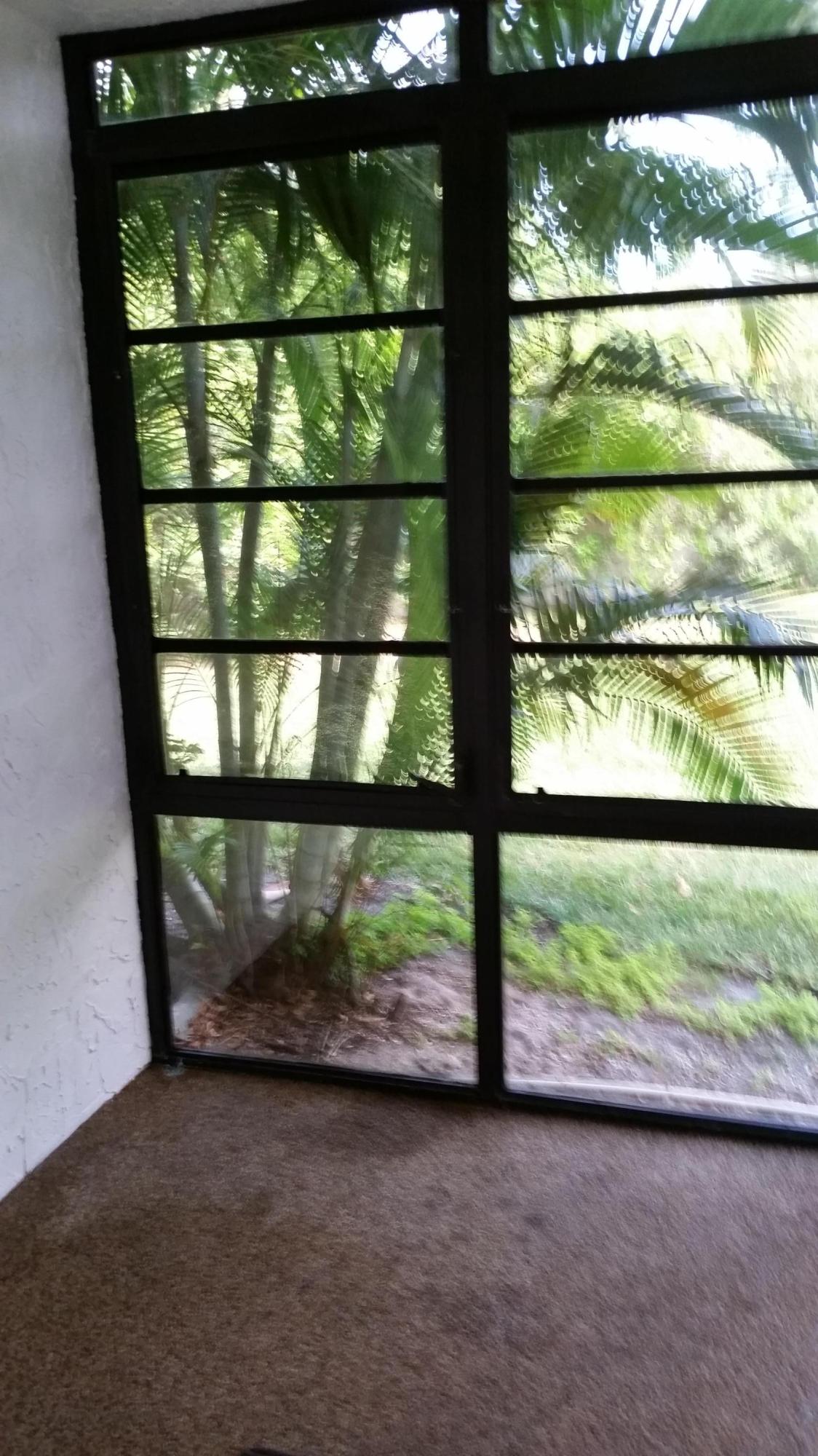 800 Northwest Fork Road, Unit 71 Stuart, FL 34994 - Photo 16 of 23 a view of a glass door with a yard from a window