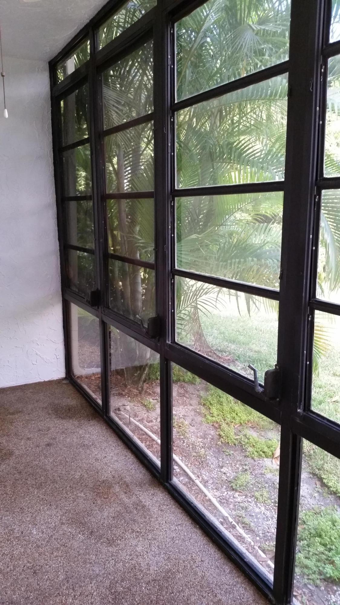 800 Northwest Fork Road, Unit 71 Stuart, FL 34994 - Photo 17 of 23 an empty room with wooden floor and a floor to ceiling window