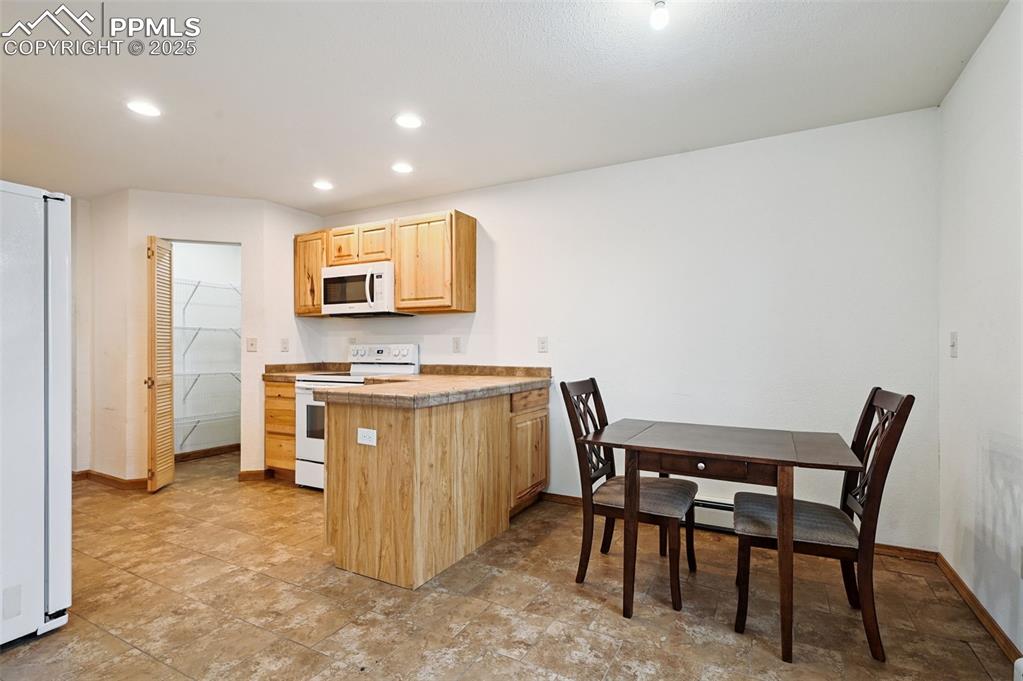 1220 Choate Lane Yoder, CO 80864 - Photo 11 of 47 a view of kitchen with stainless steel appliances granite countertop dining table chairs and a sink