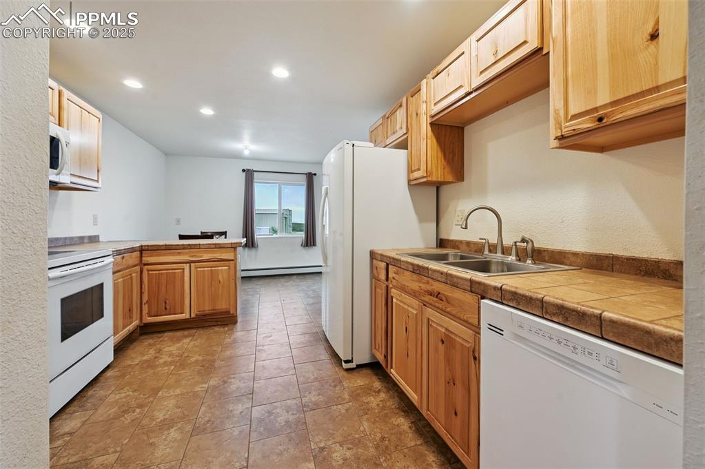 1220 Choate Lane Yoder, CO 80864 - Photo 13 of 47 a kitchen with a sink stove and cabinets