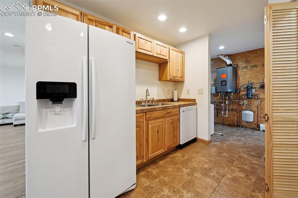 1220 Choate Lane Yoder, CO 80864 - Photo 14 of 47 a kitchen with stainless steel appliances a refrigerator stove and microwave