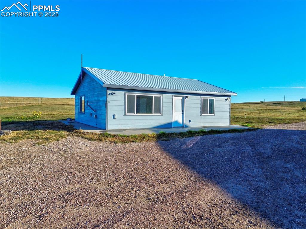 1220 Choate Lane Yoder, CO 80864 - Photo 2 of 47 a front view of a house with a yard
