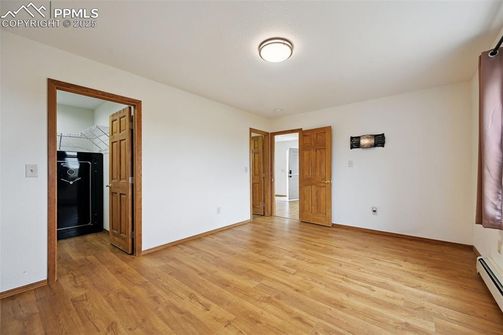 1220 Choate Lane Yoder, CO 80864 - Photo 21 of 47 a view of an empty room with wooden floor
