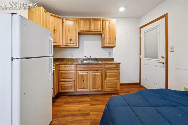 a room with a bed and wooden floor