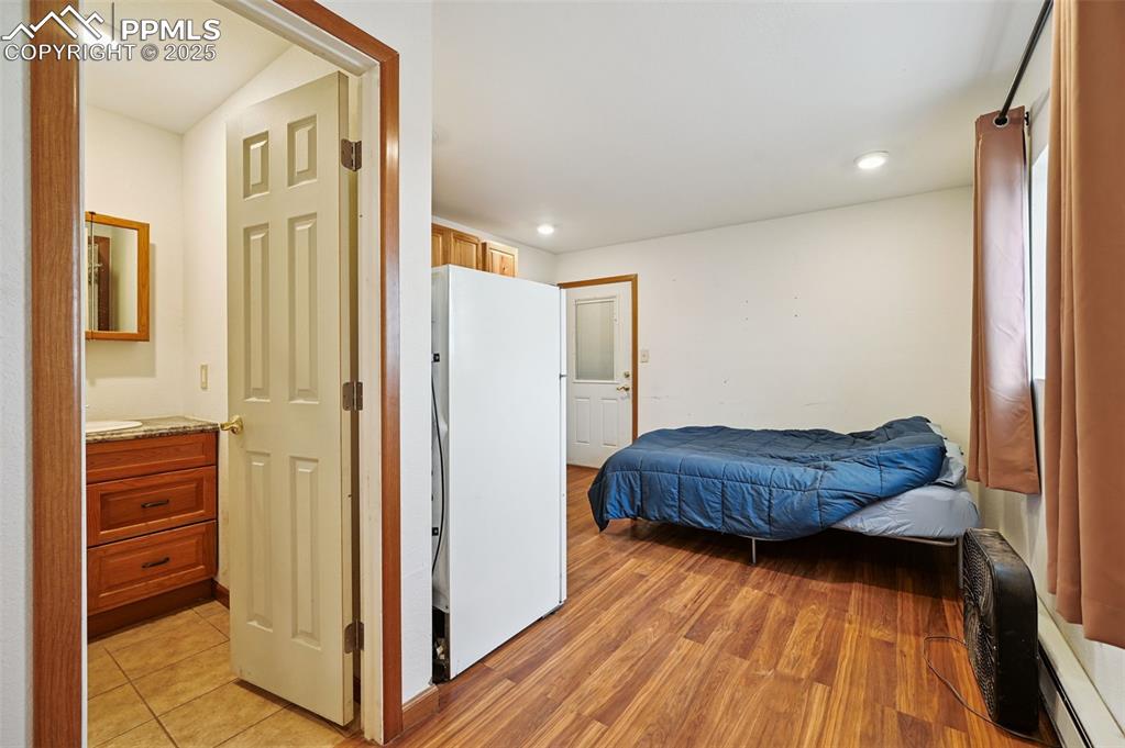 1220 Choate Lane Yoder, CO 80864 - Photo 24 of 47 a room with a bed and wooden floor