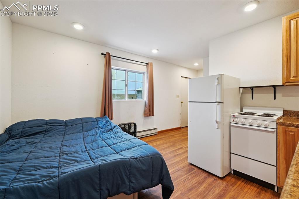 1220 Choate Lane Yoder, CO 80864 - Photo 25 of 47 a bedroom with a bed and a refrigerator