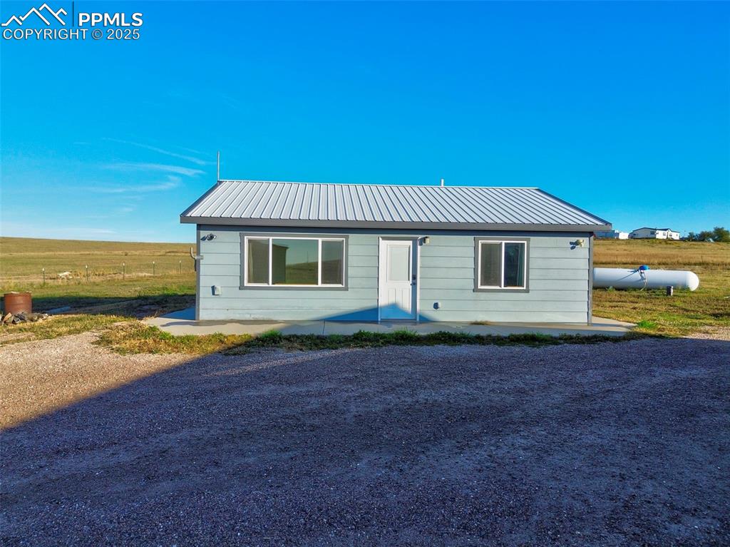 1220 Choate Lane Yoder, CO 80864 - Photo 3 of 47 a view of a house with backyard and ocean view