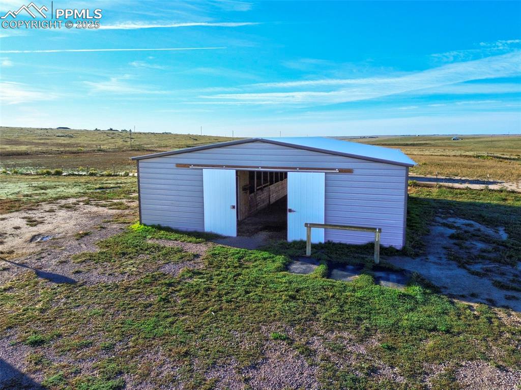 1220 Choate Lane Yoder, CO 80864 - Photo 6 of 47 a front view of a house with a yard