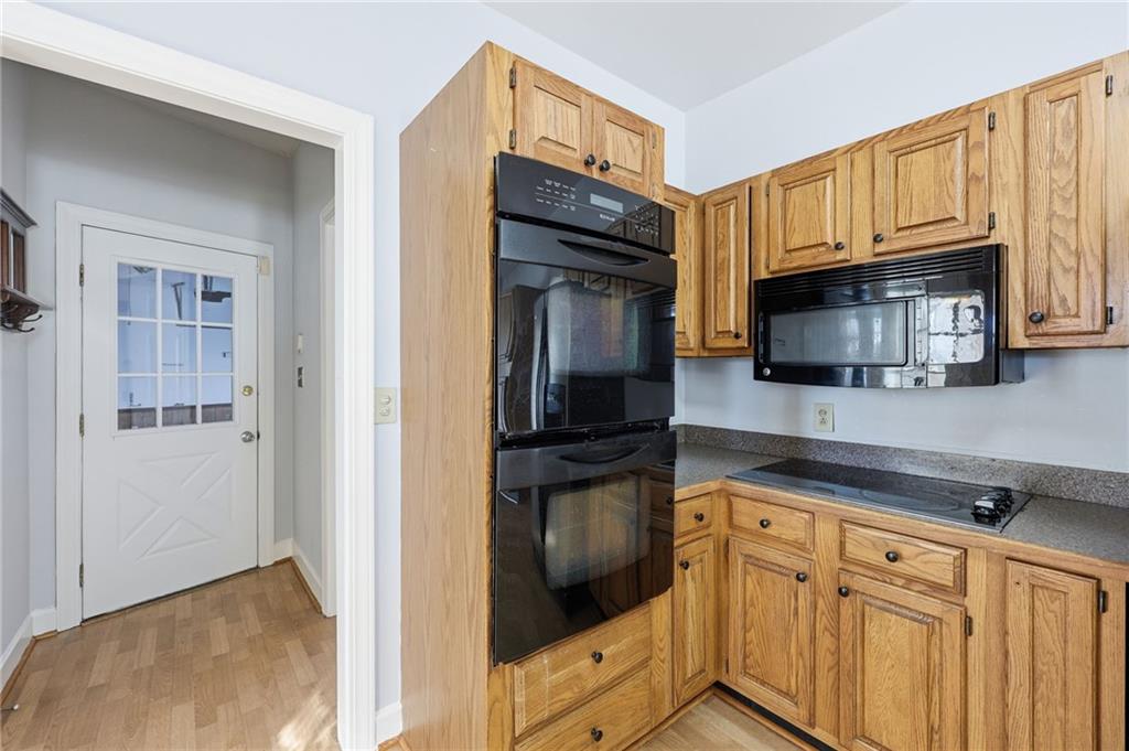 2453 Basin Court Gainesville, GA 30506 - Photo 15 of 47 a kitchen with granite countertop cabinets stainless steel appliances and wooden cabinets