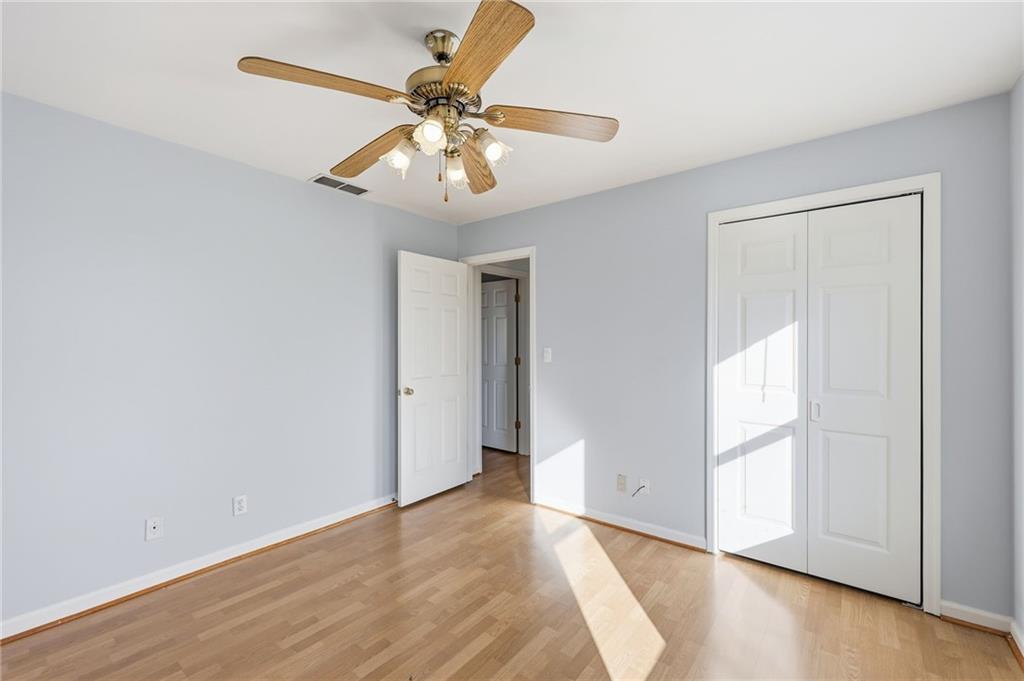 2453 Basin Court Gainesville, GA 30506 - Photo 34 of 47 an empty room with wooden floor fan and windows