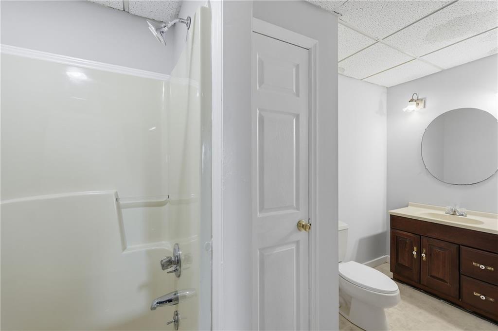 2453 Basin Court Gainesville, GA 30506 - Photo 41 of 47 a bathroom with a granite countertop sink toilet and shower