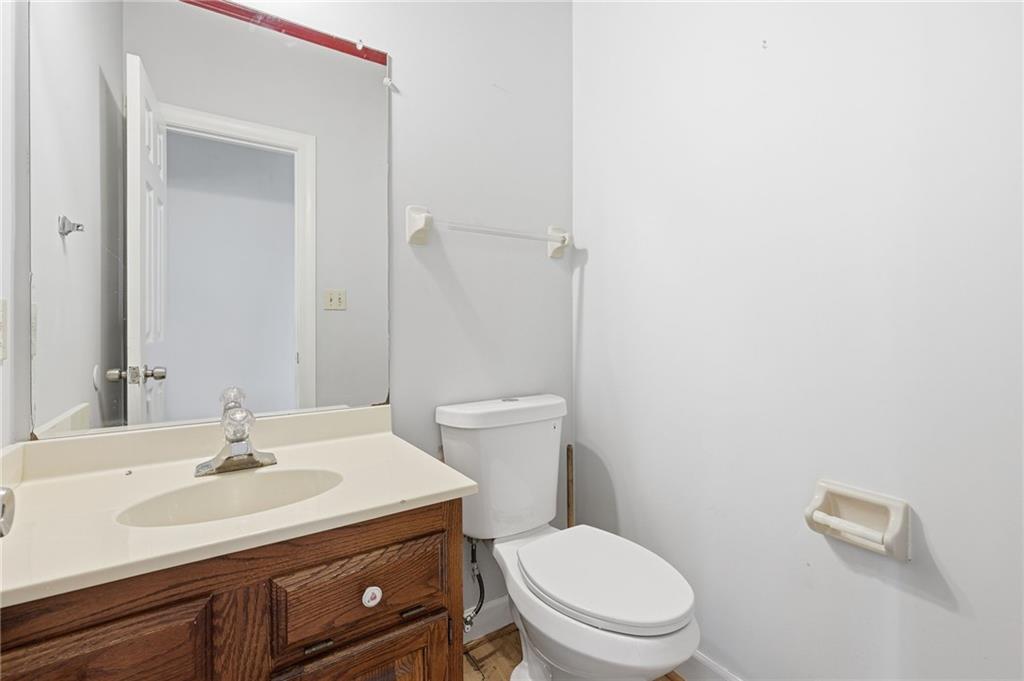 2453 Basin Court Gainesville, GA 30506 - Photo 42 of 47 a bathroom with a sink a toilet and a mirror