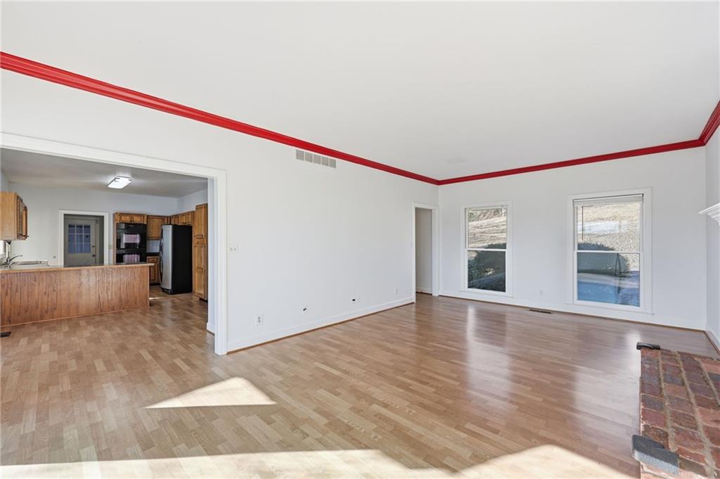 2453 Basin Court Gainesville, GA 30506 - Photo 9 of 47 a view of empty room with wooden floor and fan
