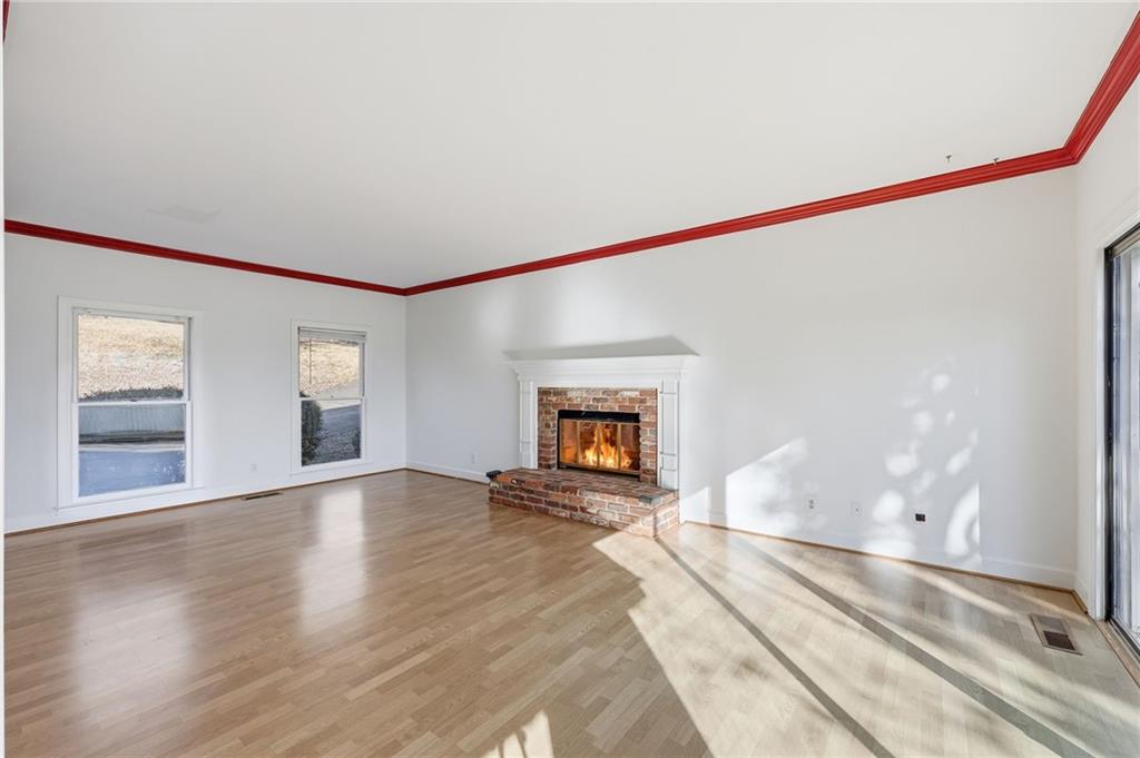 2453 Basin Court Gainesville, GA 30506 - Photo 10 of 47 a view of an empty room with wooden floor and a window