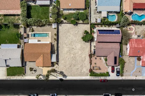 an aerial view of multiple houses with yard