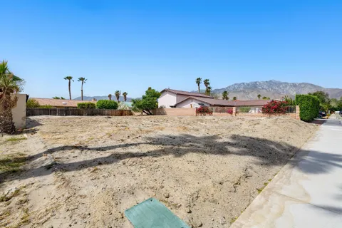 a view of a dirt road with a building in the background