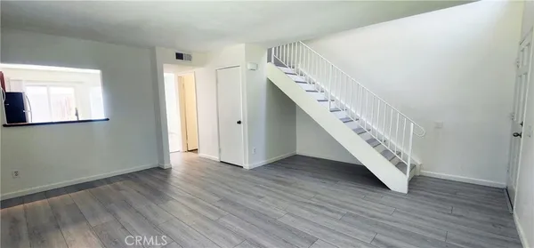 a view of an entryway with wooden floor