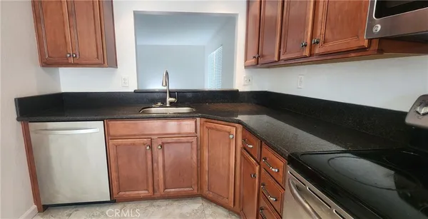 a kitchen with granite countertop cabinets and a sink