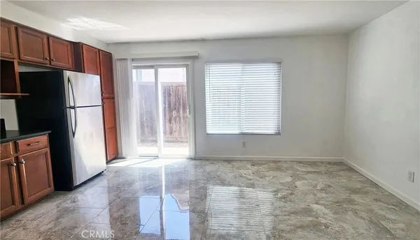 a view of an empty room with a kitchen