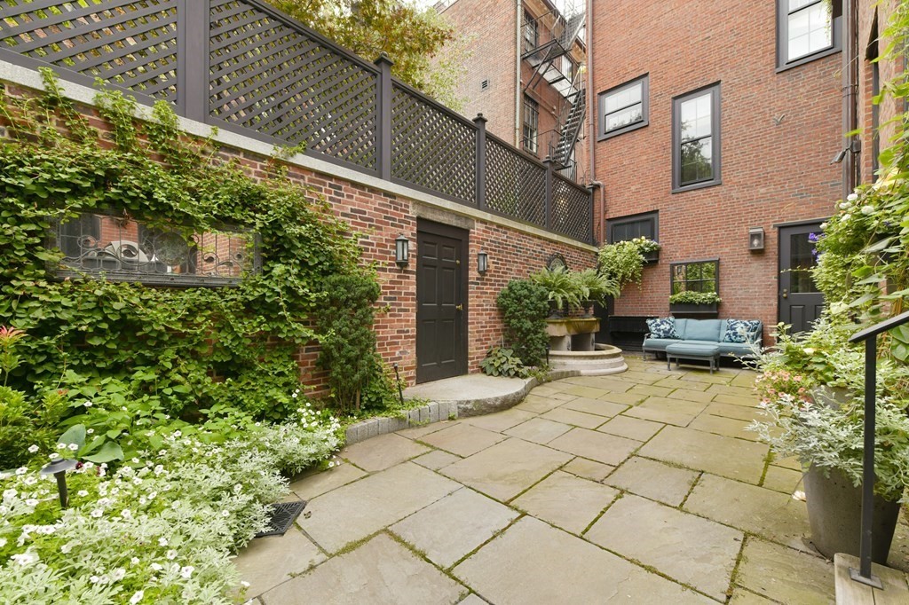 59 Chestnut Street Boston, MA 02108 - Photo 11 of 33 a view of a chair and table in backyard of the house