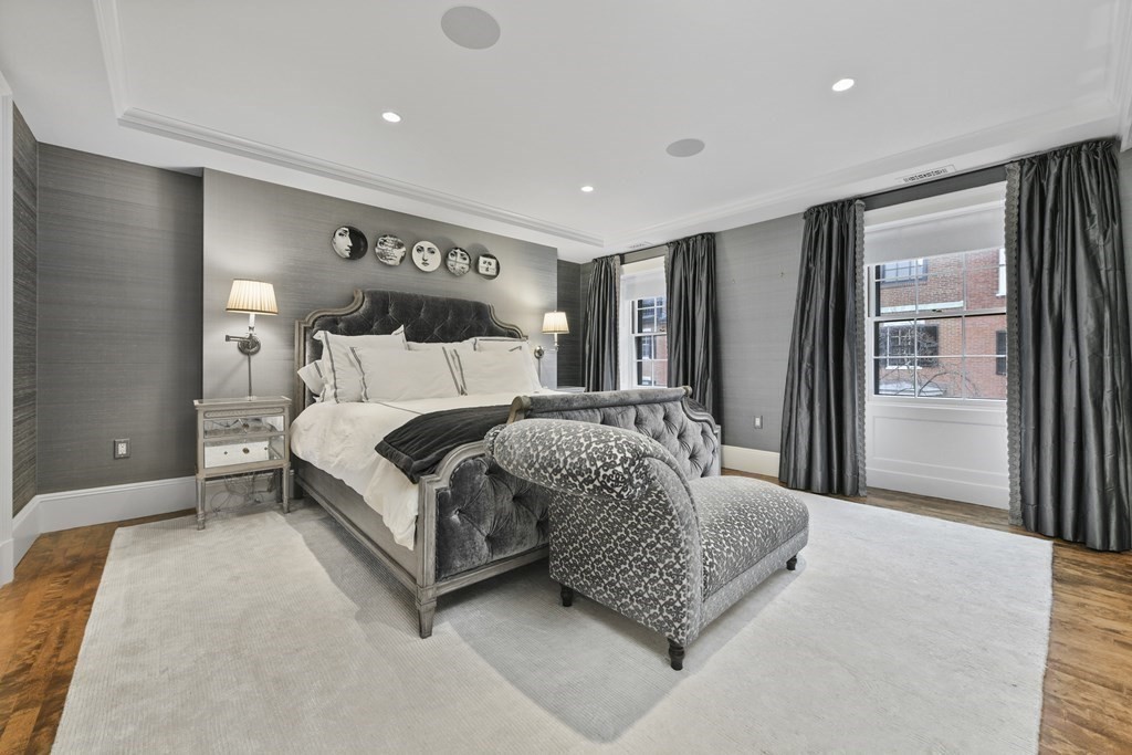 59 Chestnut Street Boston, MA 02108 - Photo 20 of 33 a bedroom with a large bed and a chandelier