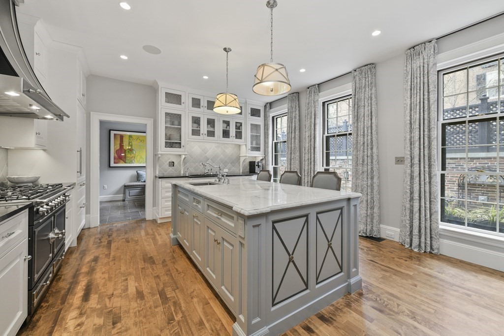 59 Chestnut Street Boston, MA 02108 - Photo 6 of 33 a large kitchen with stainless steel appliances granite countertop a stove and a wooden floors