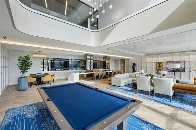 a living room with furniture and view of kitchen