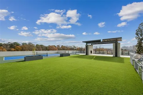 a view of a big room with pool table and a fire pit