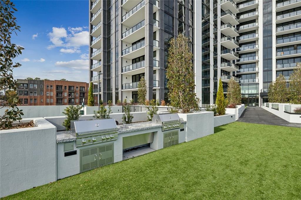 2425 Peachtree Street Northeast, Unit 1106 Atlanta, GA 30305 - Photo 26 of 43 a large building with a sink and dishwasher a barbeque with yard