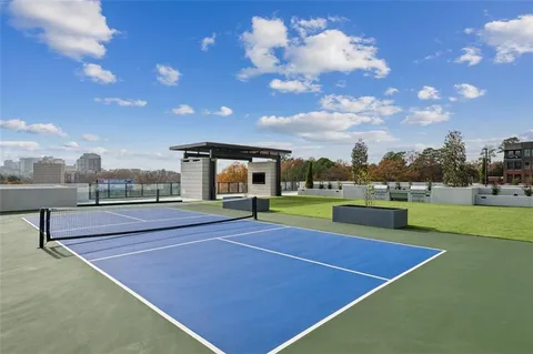 a view of building with swimming pool and outdoor seating