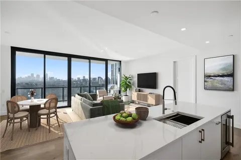 a kitchen with a large window and furniture