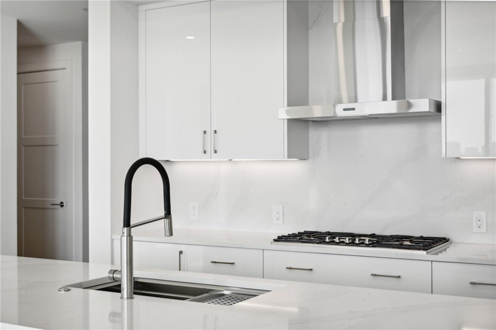 2425 Peachtree Street Northeast, Unit 1106 Atlanta, GA 30305 - Photo 4 of 43 a kitchen with white cabinets and appliances