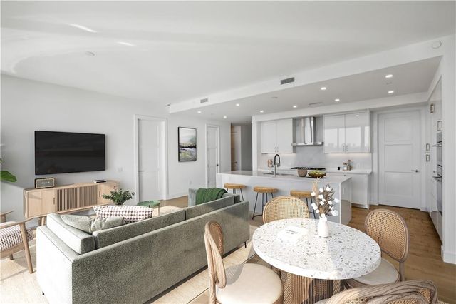 a kitchen with a stove a sink a dining table and chairs