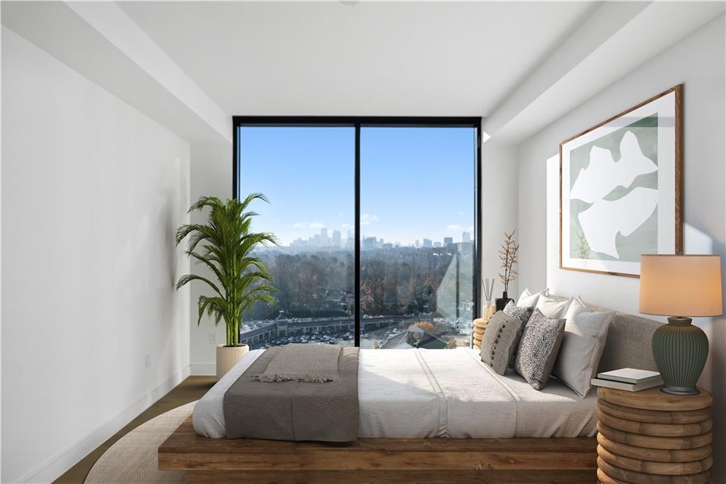 2425 Peachtree Street Northeast, Unit 1106 Atlanta, GA 30305 - Photo 7 of 43 a bedroom with a large bed and a potted plant