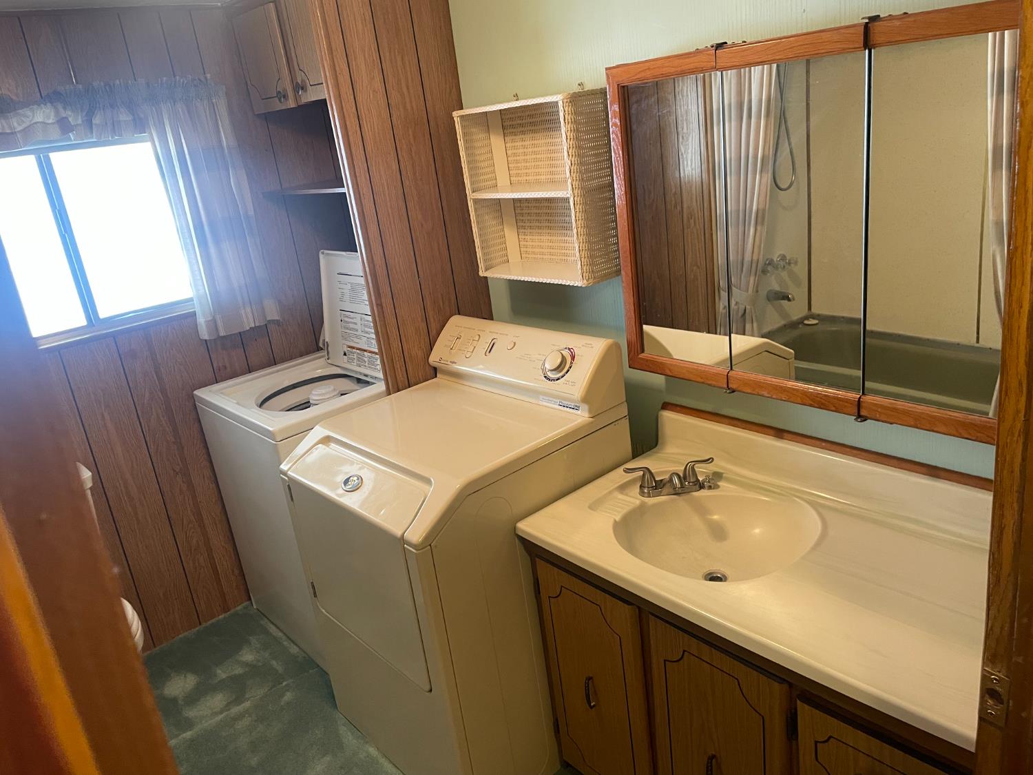 5835 Cherokee Road, Unit 52 Stockton, CA 95215 - Photo 14 of 19 a bathroom with a sink and a washing machine