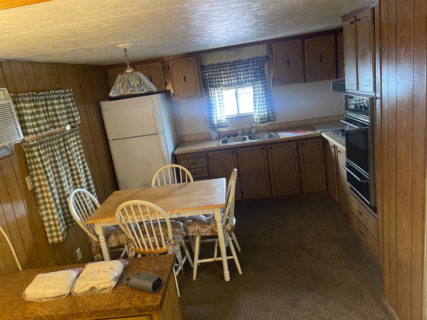 5835 Cherokee Road, Unit 52 Stockton, CA 95215 - Photo 6 of 19 a kitchen with stainless steel appliances kitchen island granite countertop a sink a table and chairs in it