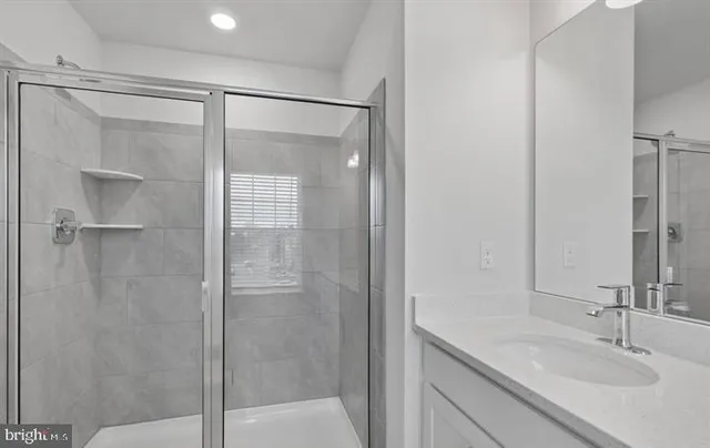 a bathroom with a shower and a sink