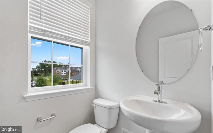 8710 Cherrybark Road Clinton, MD 20735 - Photo 7 of 19 a bathroom with a toilet sink and mirror