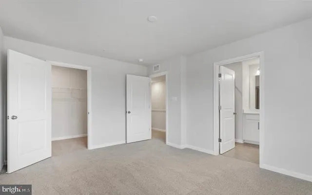 a view of an empty room and closet area