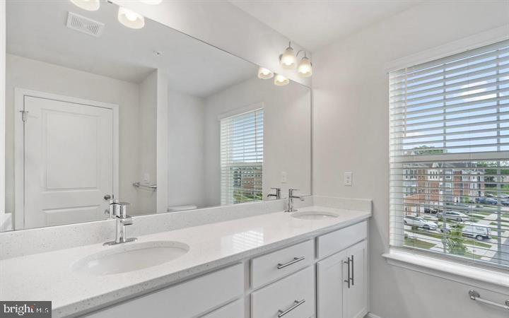 8710 Cherrybark Road Clinton, MD 20735 - Photo 10 of 19 a bathroom with double vanity and a mirror
