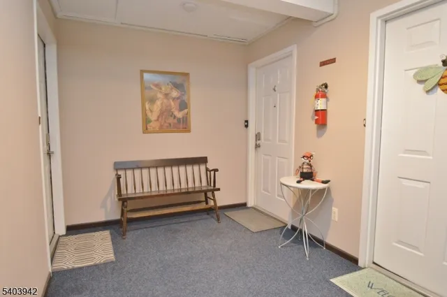 a view of a room with wooden floor and a window